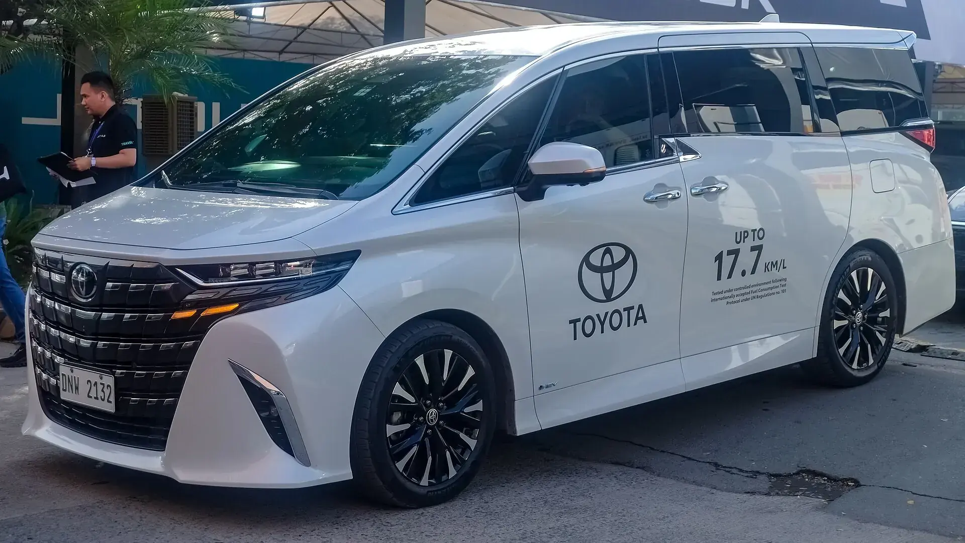A Japanese luxury multi-purpose vehicle finished in white pearl, front three-quarter view.