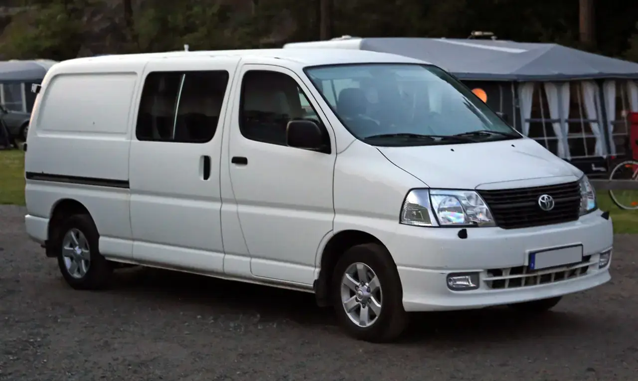 A long-wheelbase Japanese panel van photographed side-on.
