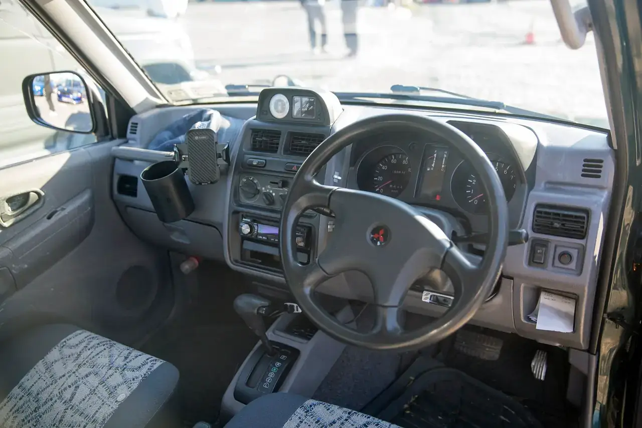 Dashboard and instrument cluster of a Japanese-market compact car.