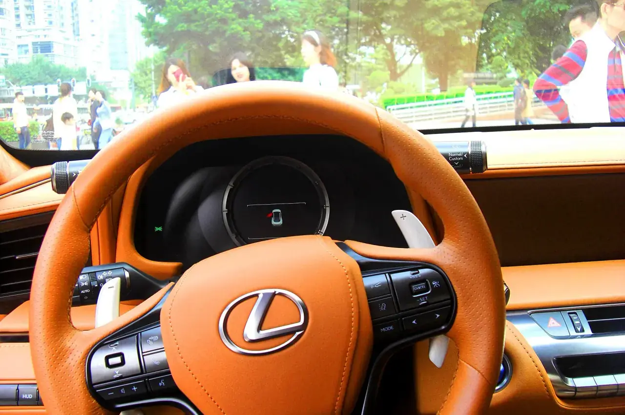 Driver-focused luxury cabin with layered trim and instrumentation.
