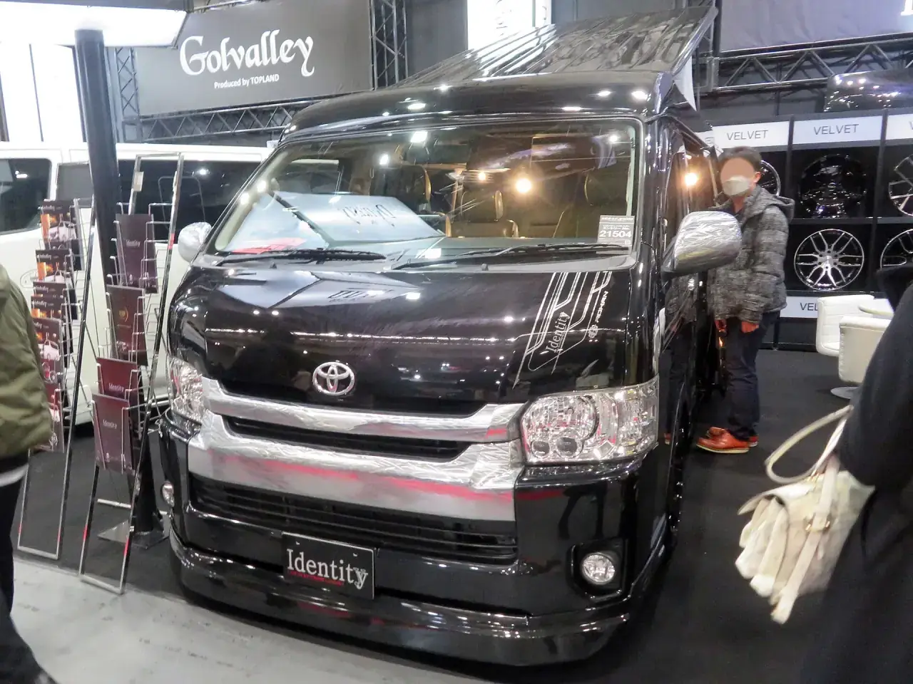 A modified Japanese van displayed at an indoor automotive exhibition in Osaka.